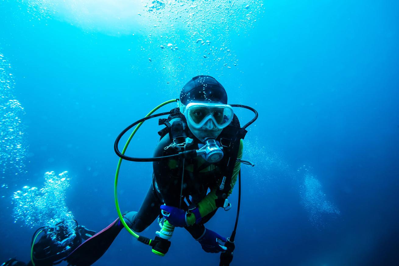 Diver above dive buddy