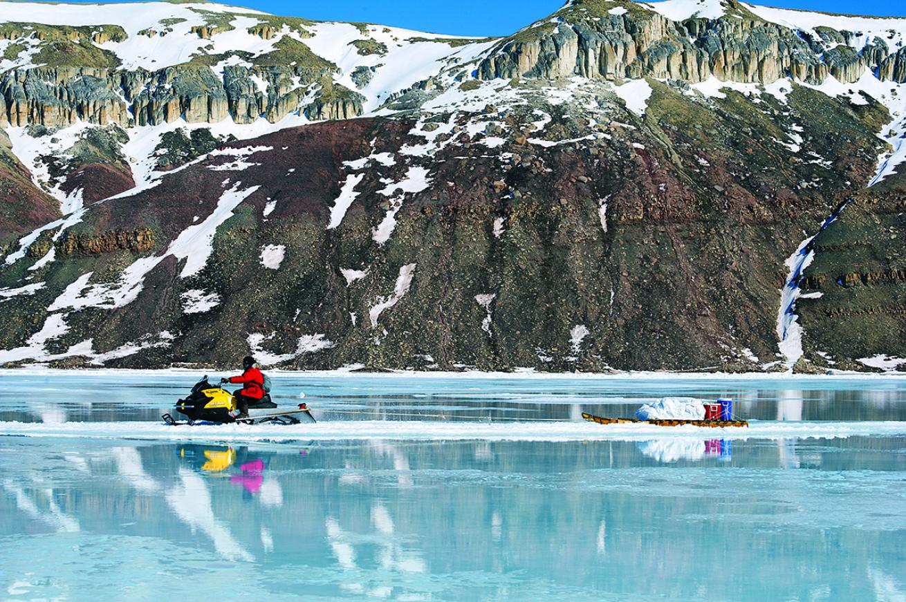 Snowmobile crosses the ice in Arctic Bay, Canada