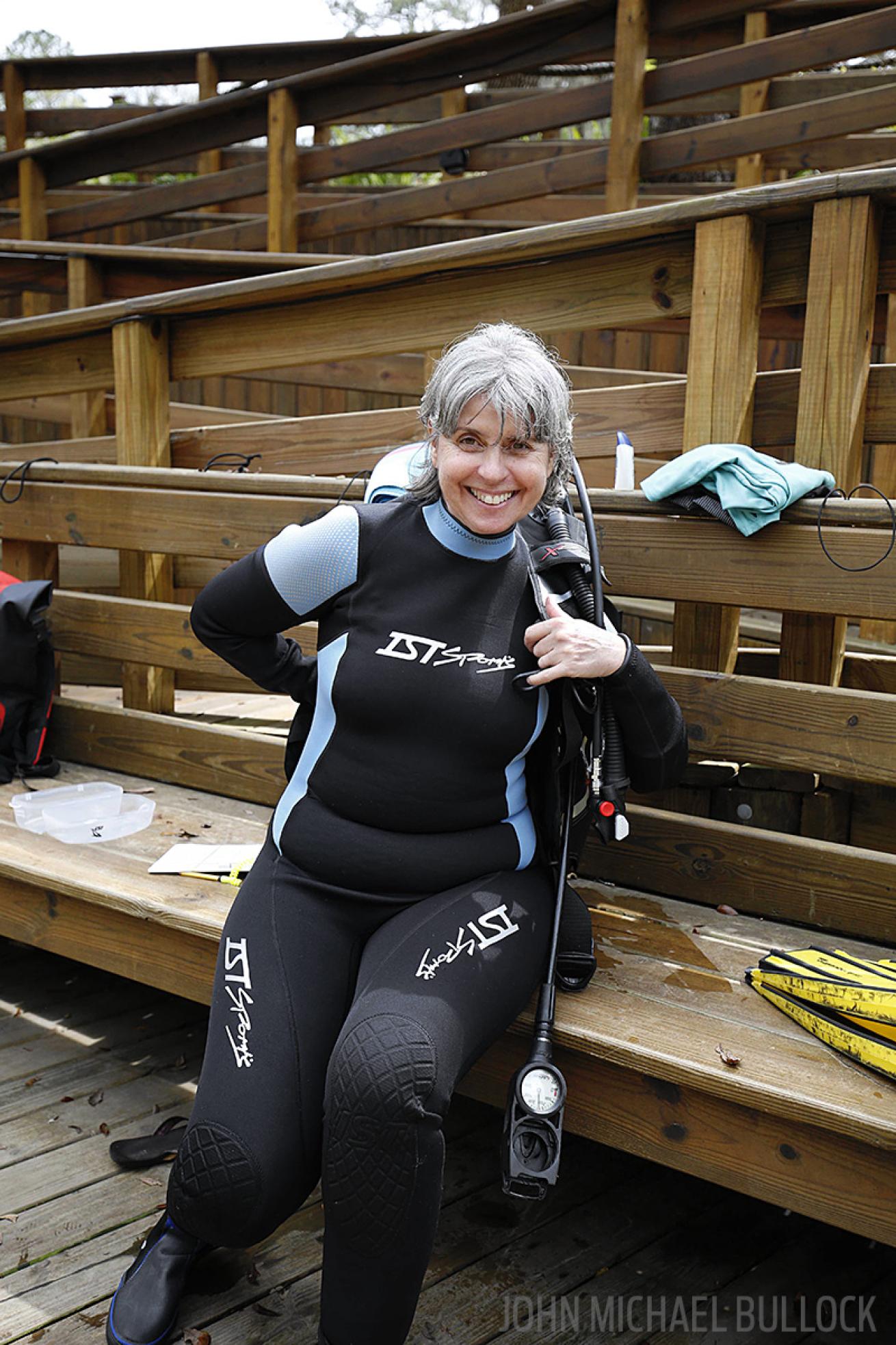 Scuba diver dons gear for ScubaLab BC test at Blue Grotto