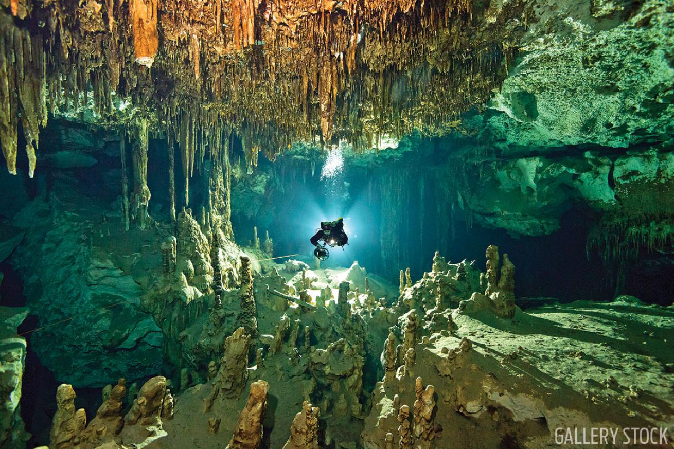 Scuba diver explores cenote in Mexico