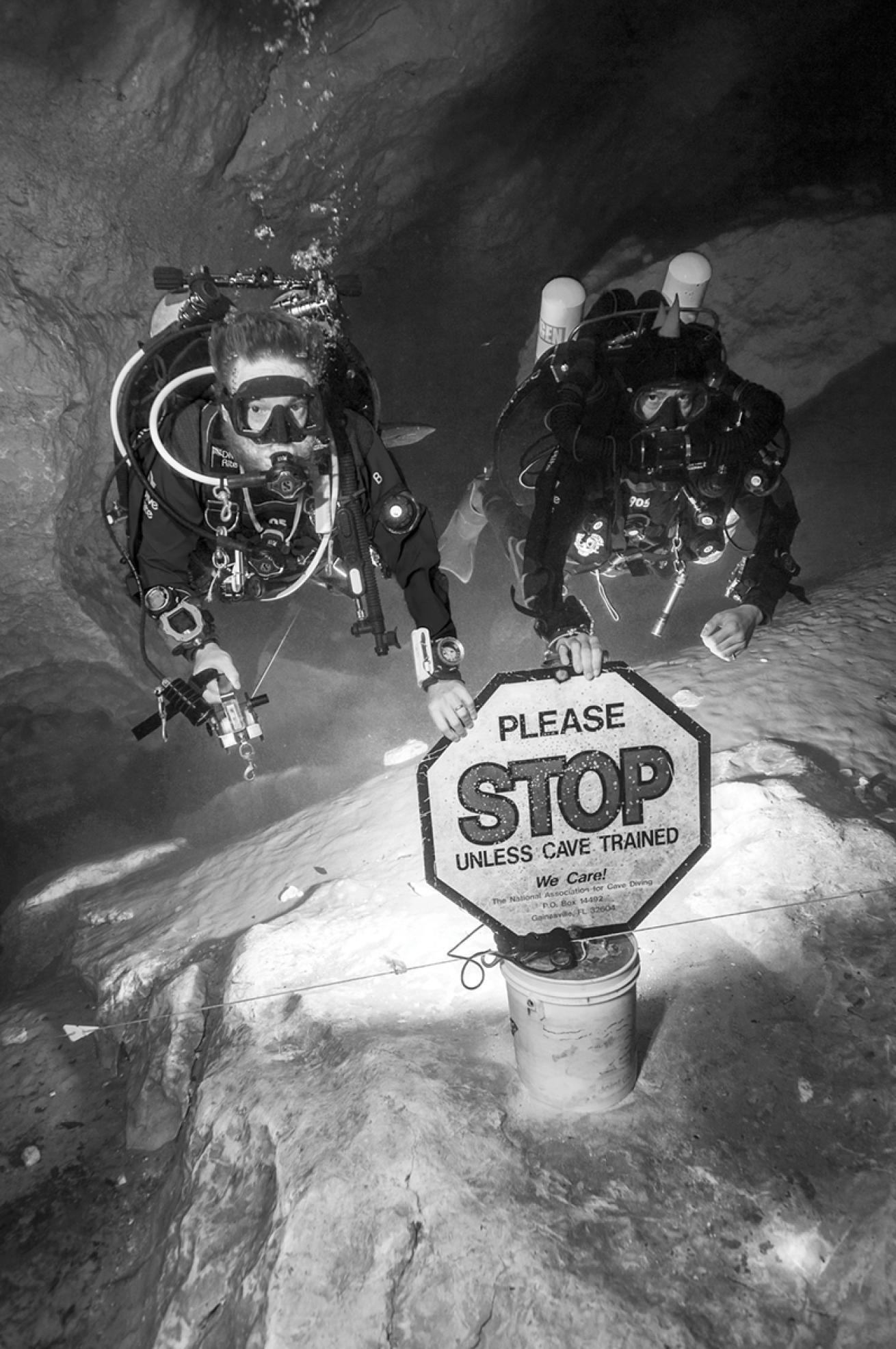 Jill Heinerth cave diving with buddy and sign