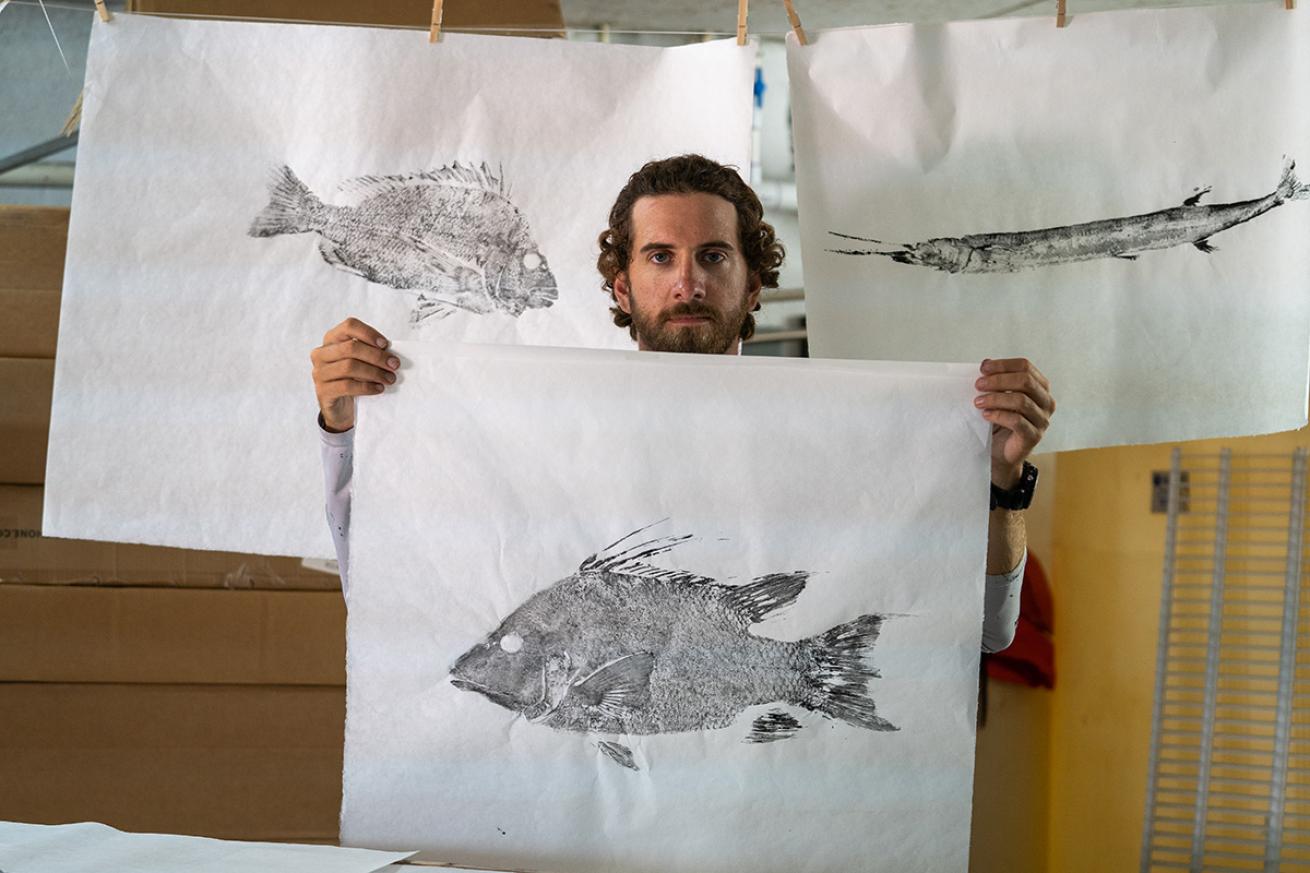 Gyotaku artist with prints