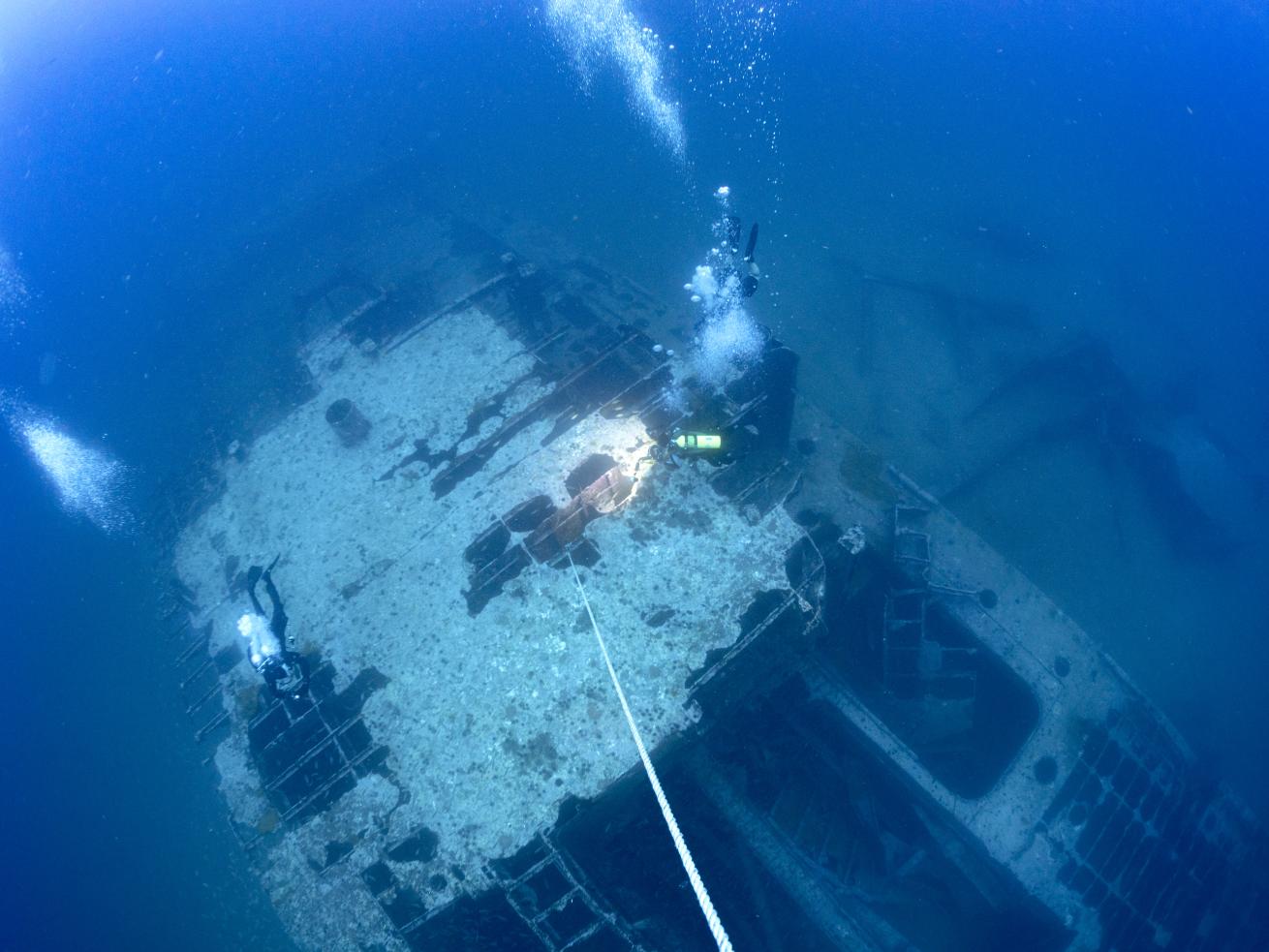 A group of scuba divers swimming in the water