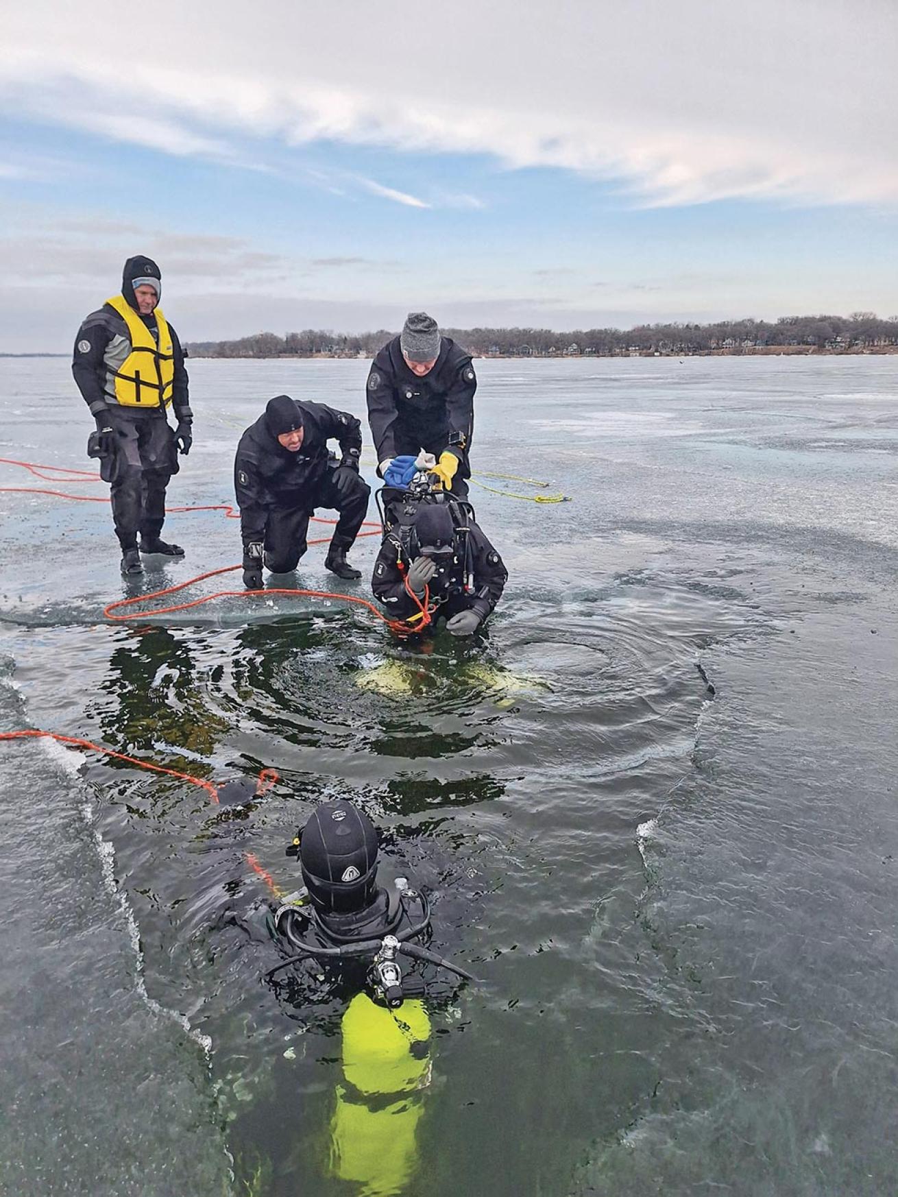 Divers take the plunge into a frigid West Okoboji Lake.