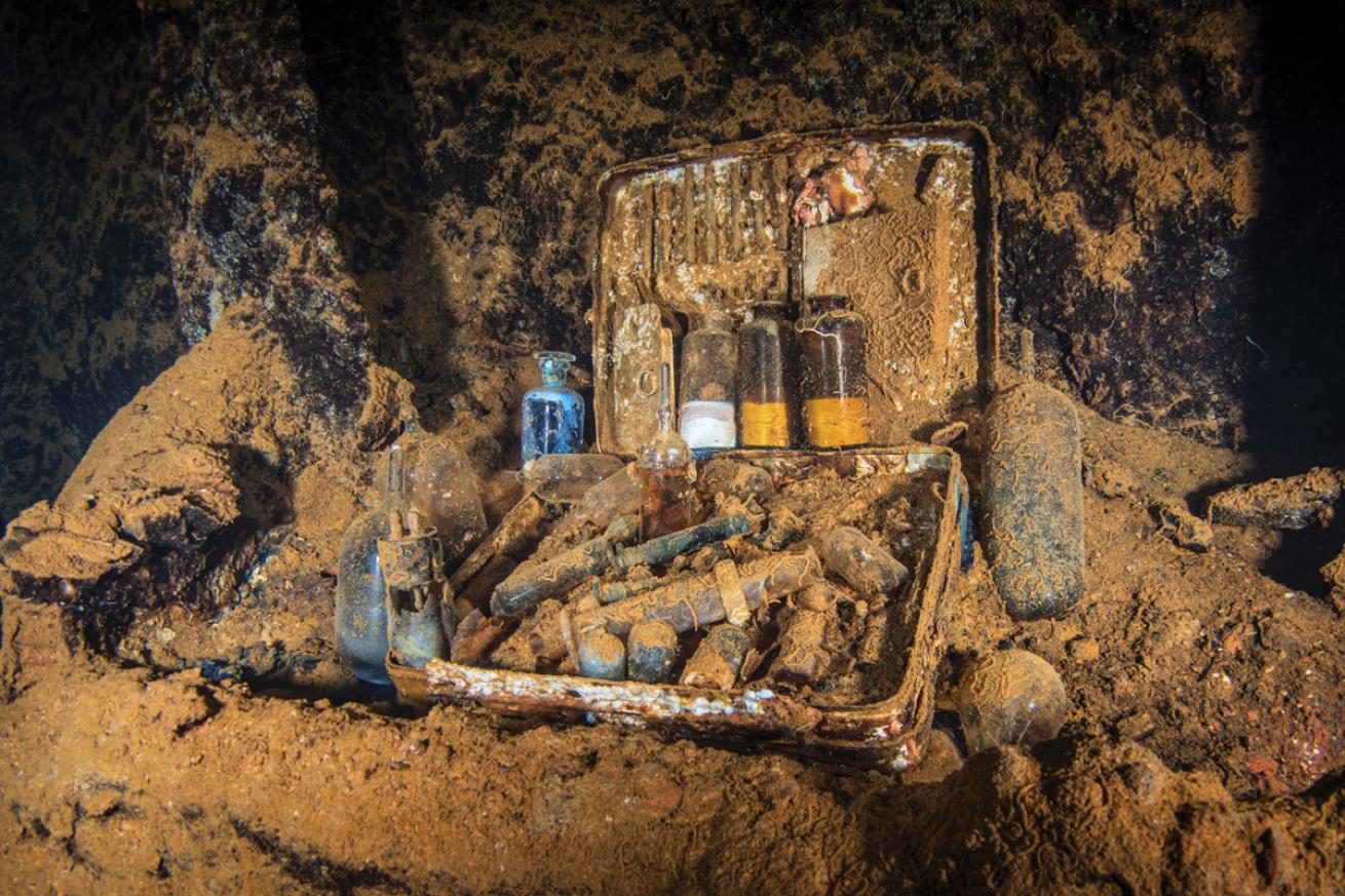 A medical kit lies open on *Heian Maru*, medicine bottles and other medical equipment on display