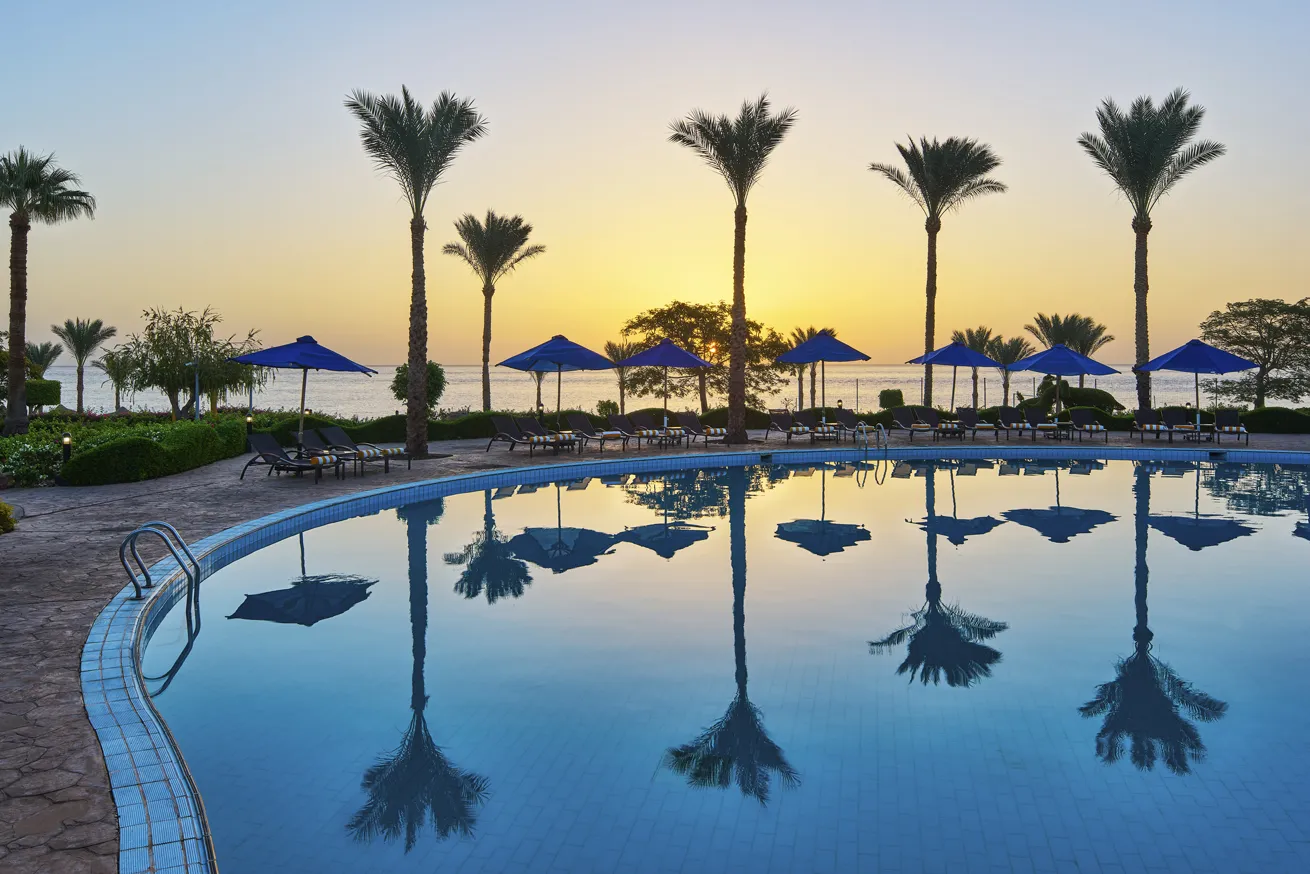 A picture-perfect sunset as seen from one of the four outdoor pools guests can relax by