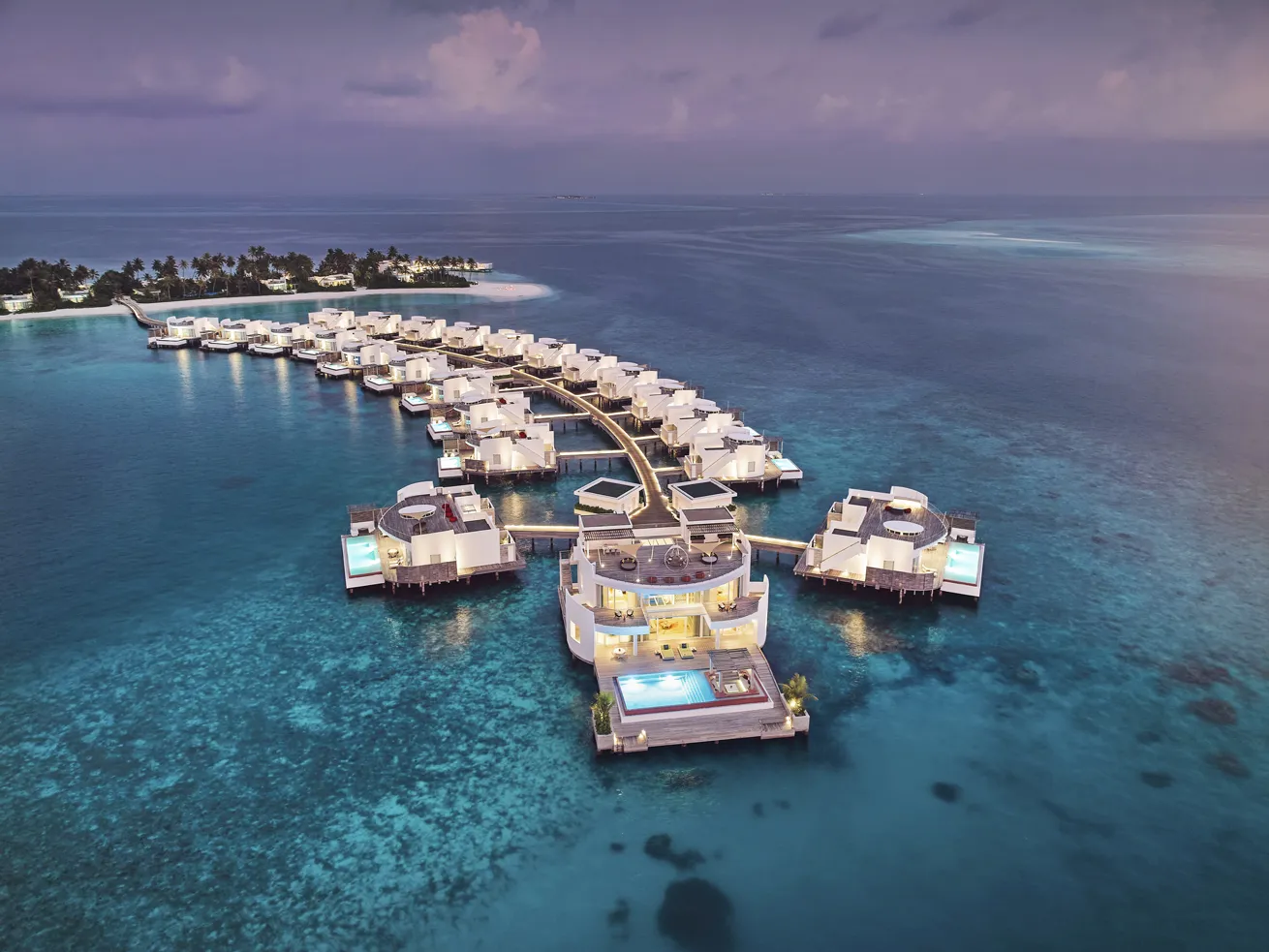 The Jumeirah Olhahali Island villas stretch outward, transporting guests directly to the ocean.