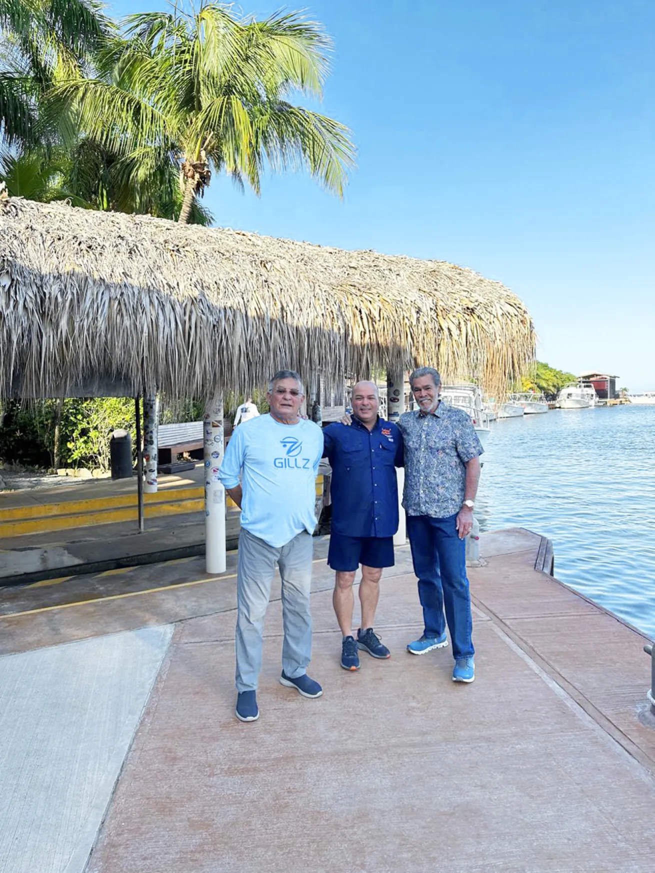 Galindo stands with his son Samir (middle) and dive legend Peter Hughes (right).