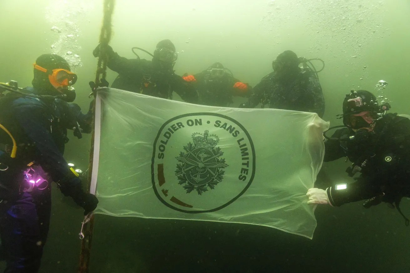 Divers fly the Canadian Armed Forces’ Soldier On flag at depth off the coast of Vancouver Island.