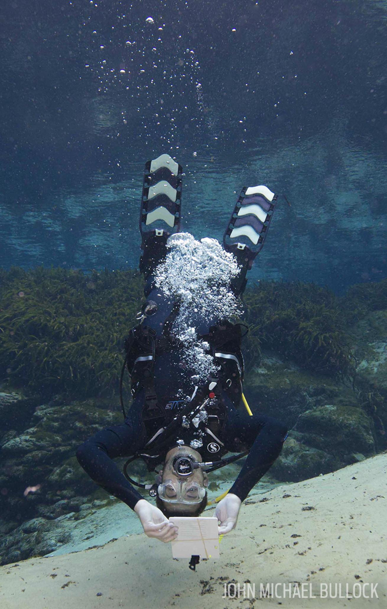 Scuba diver upside down underwater ScubaLab regulator test