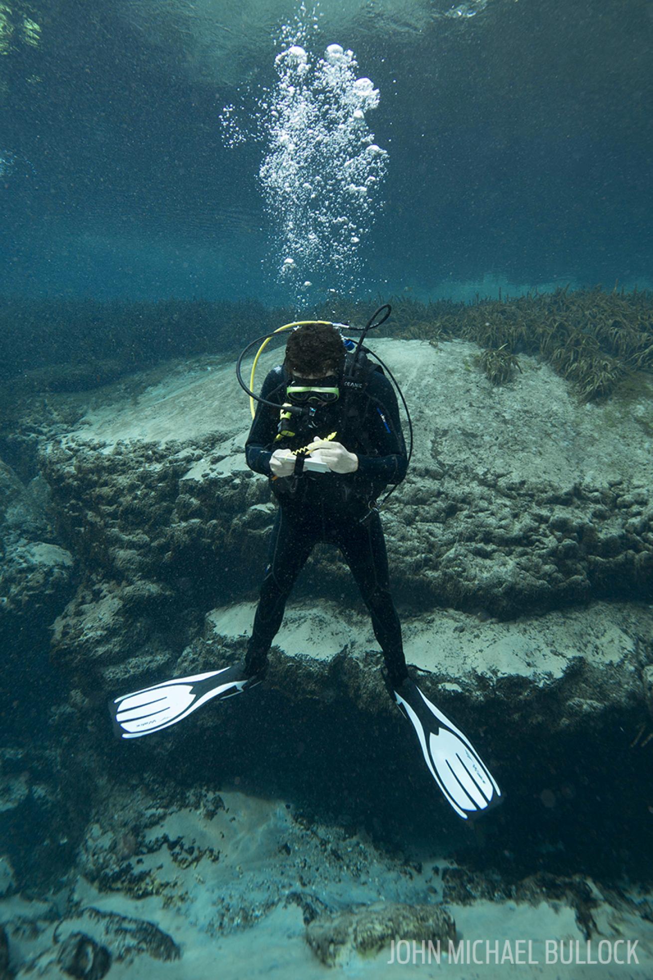 Scuba diver underwater testing regulators at Alexander Springs, Florida