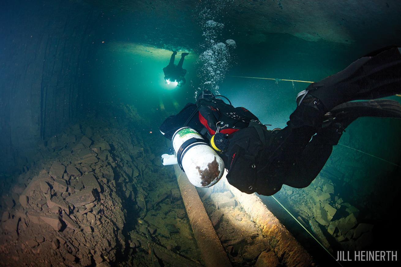 Scuba divers explore the inside of Bell Islands abandoned mines