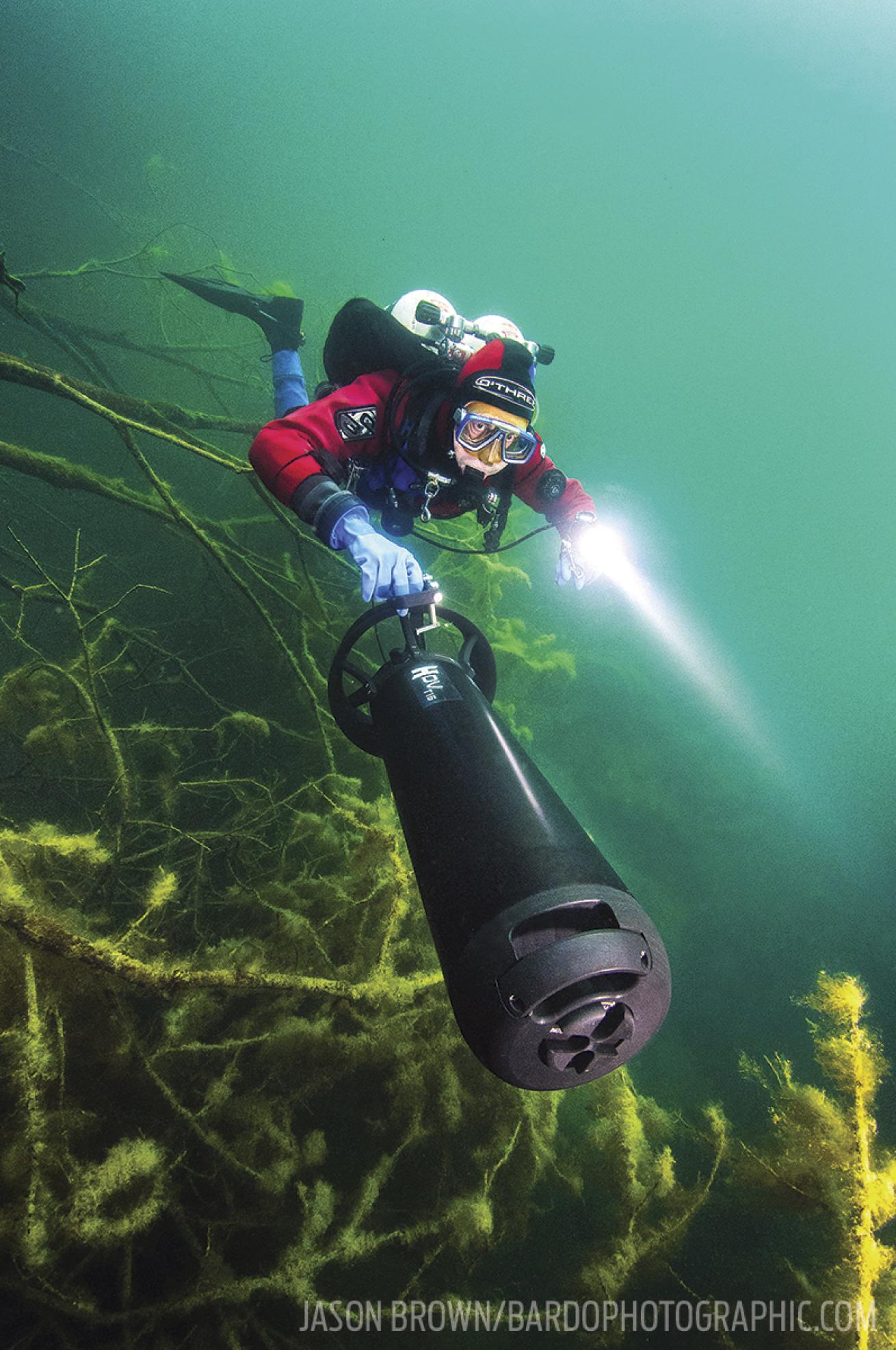 scuba diver using an underwater scooter dpv