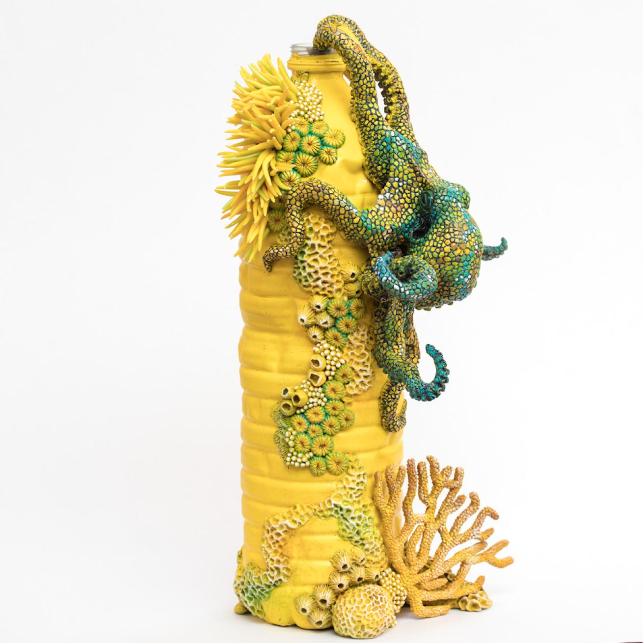 Clay octopus climbs yellow water bottle