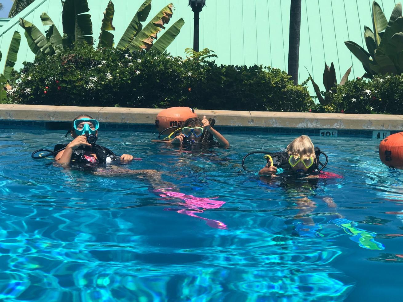 children floating in pool
