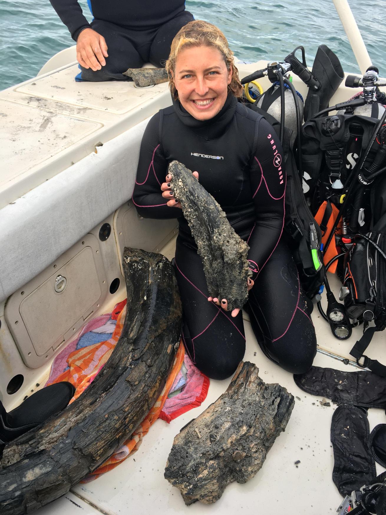 Diver poses with mammoth tusk discovered in Gulf of Mexico