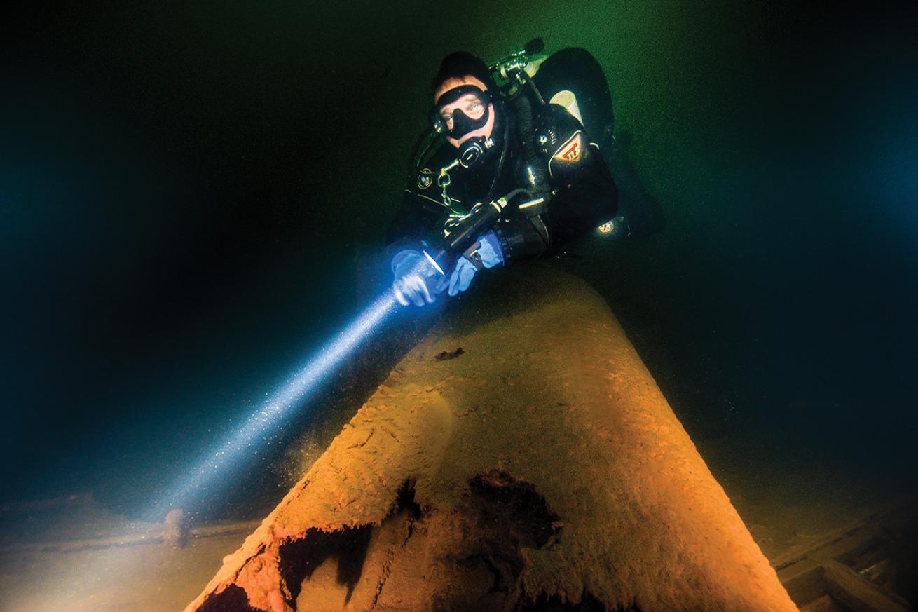 A diver explores the *Spokane&#039;s* smokestack on the bottom of Lake Couer d&#039;Alene.