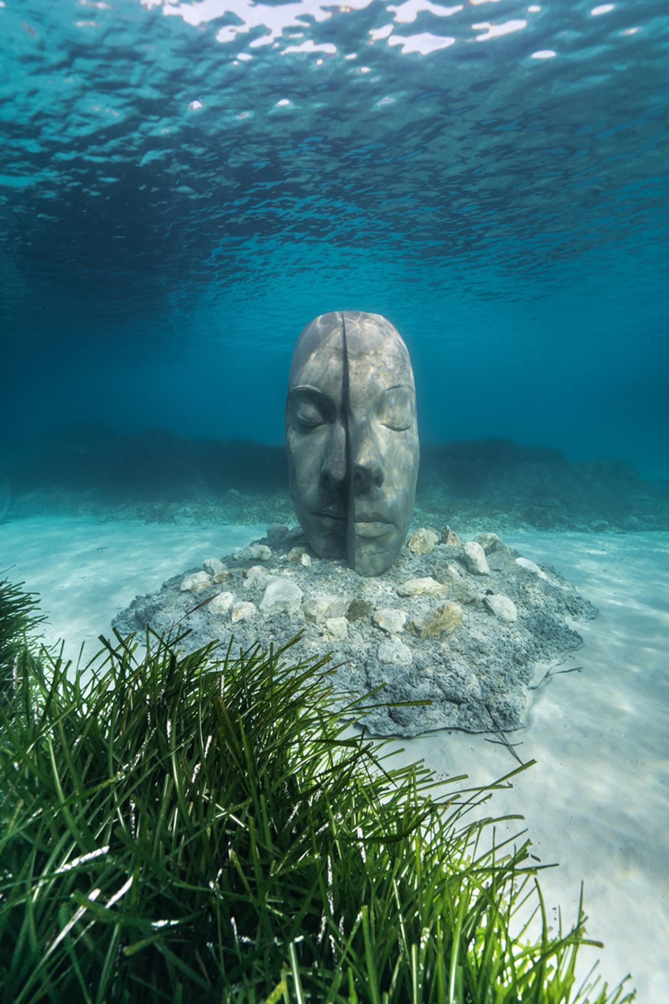 Jason deCaires Taylor split face sculpture on the seabed