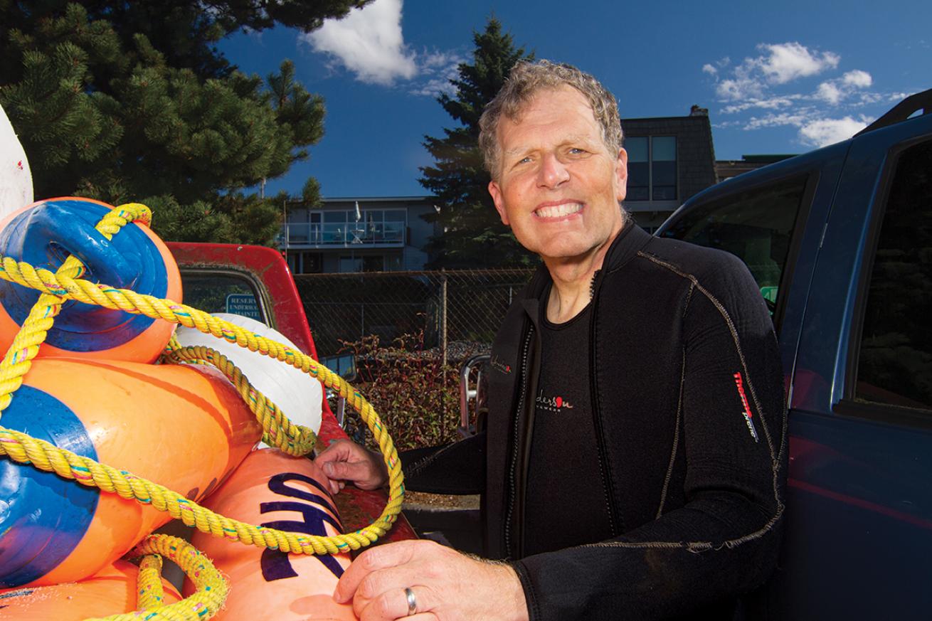 Bruce Higgins stands truck loaded with buoys.