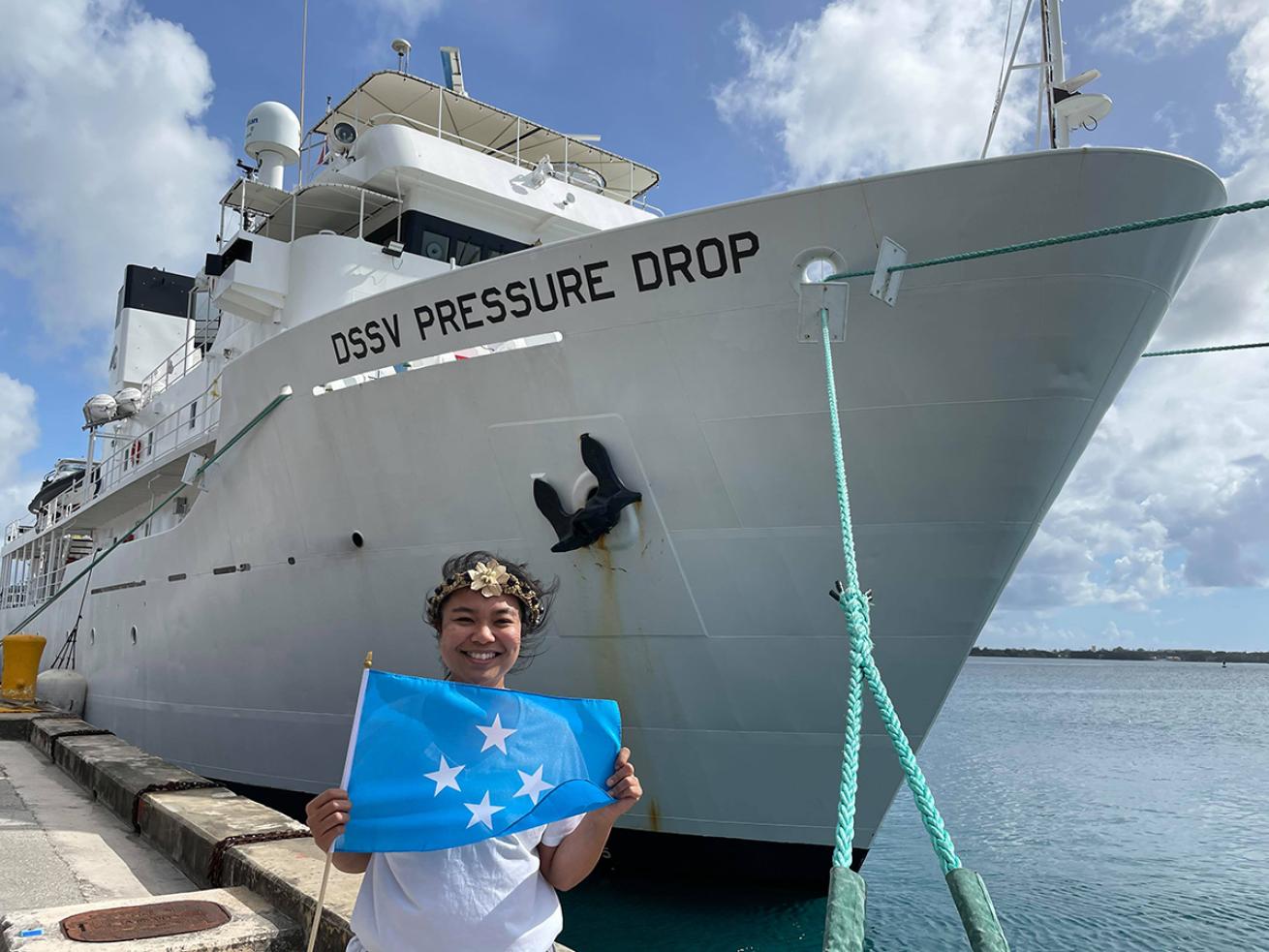 Nicole Yamase holds the Micronesian flag next to the DSSV Pressure Drop