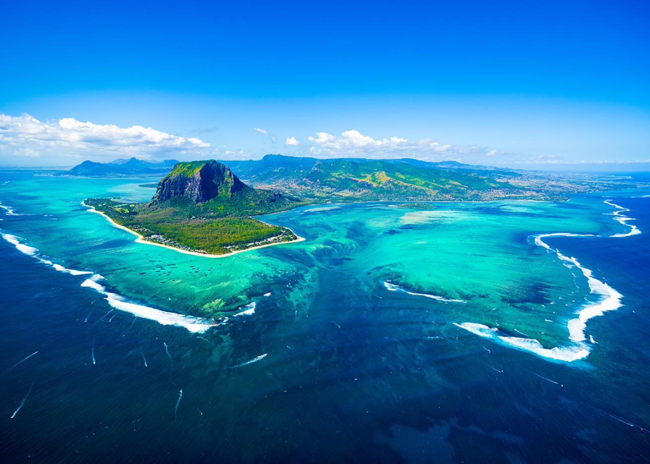 An aerial panorama of Mauritius surrounded by cobalt blue waters