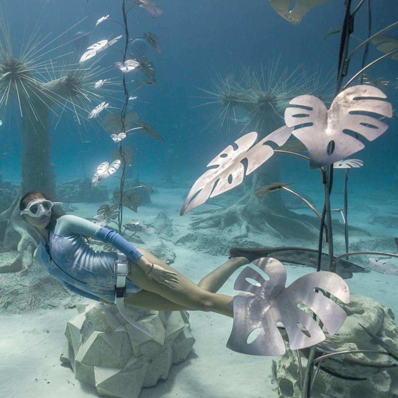 Freediver among underwater sculptures