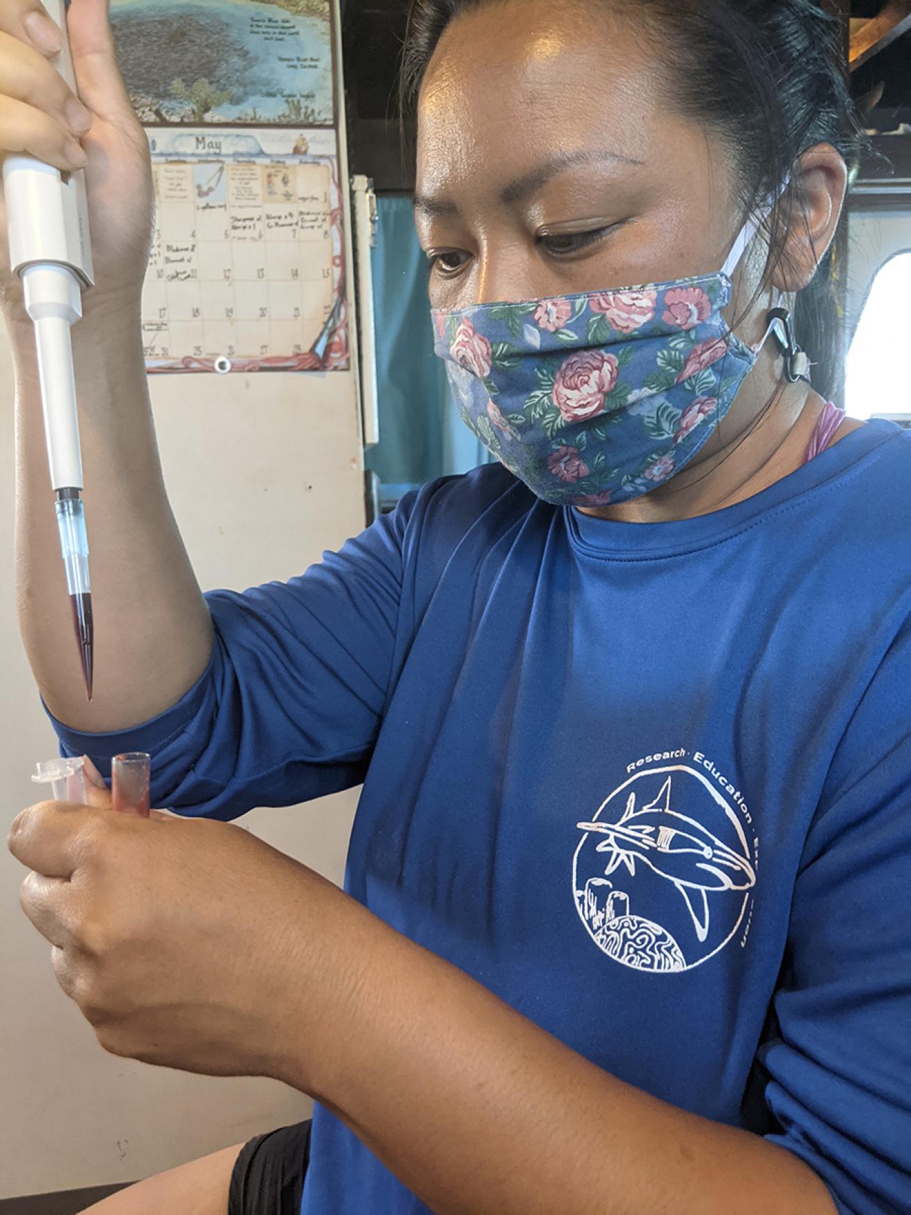 Woman holds shark blood sample
