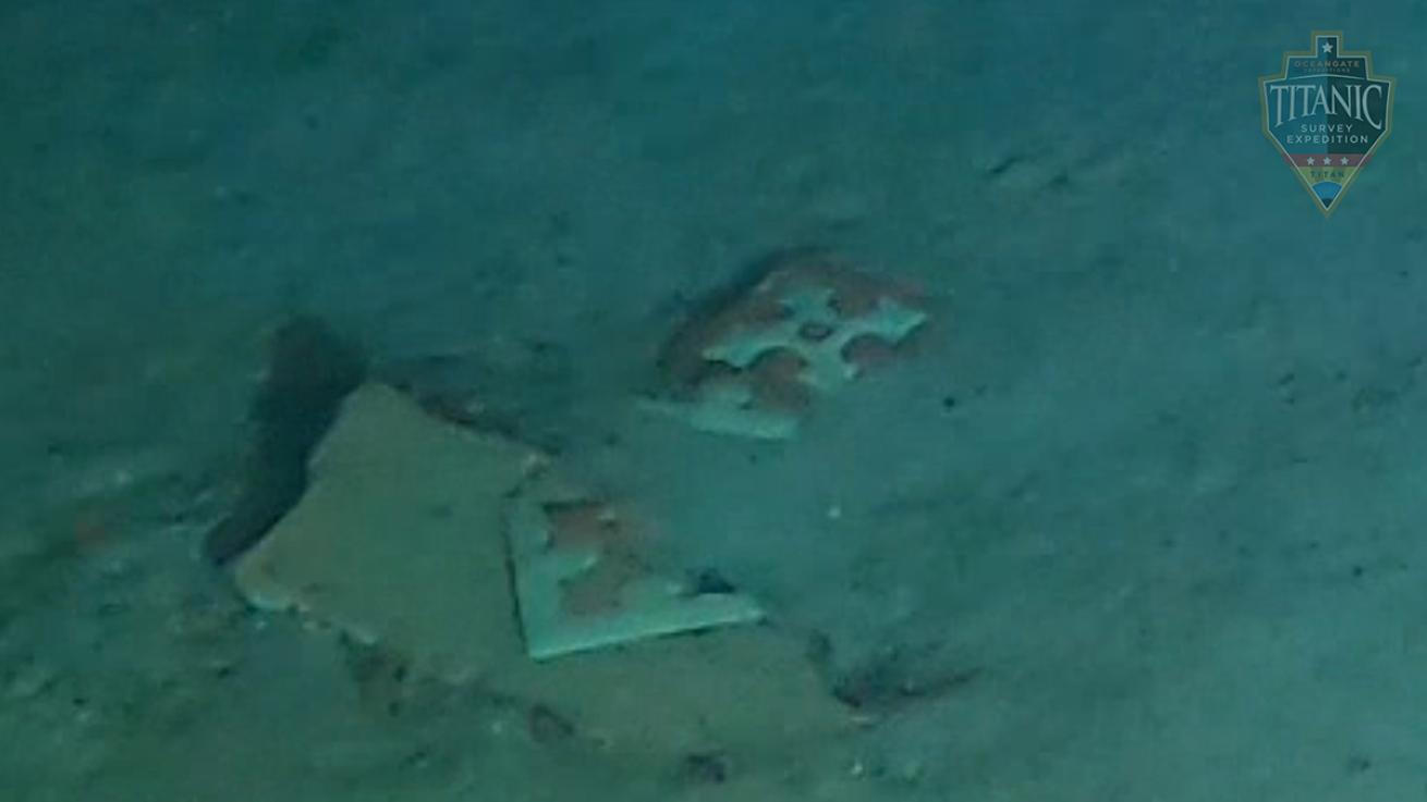 A broken floor tile rests in oceanic substrate.