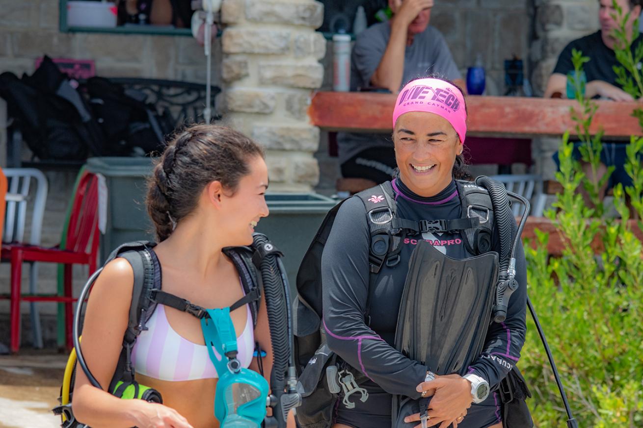 Two female divers smiling topside