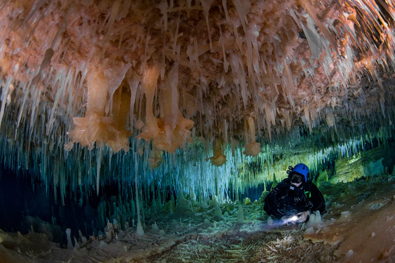 Cave diver under rose crystals