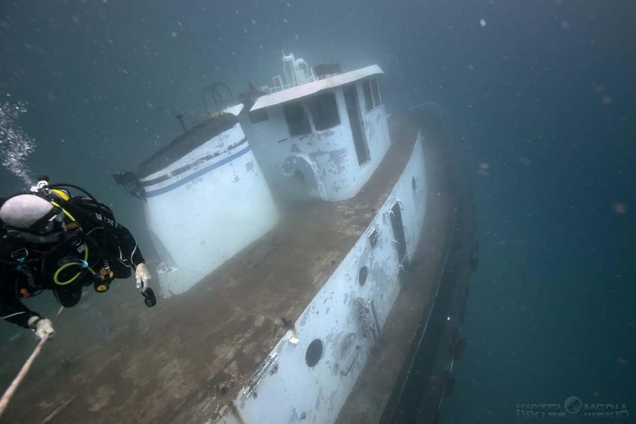 Diver near tugboat being scuttled