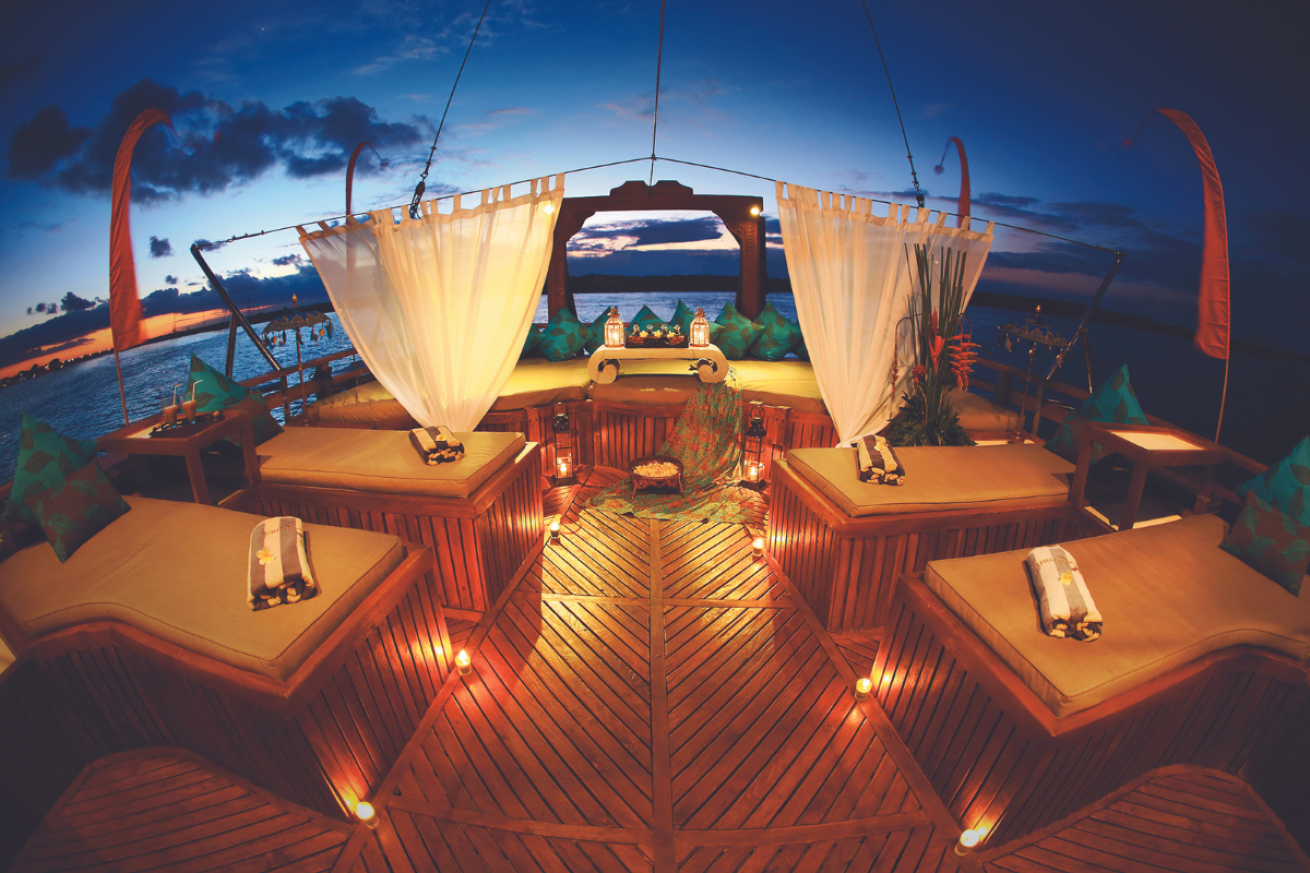 A large boat deck with tables and chairs