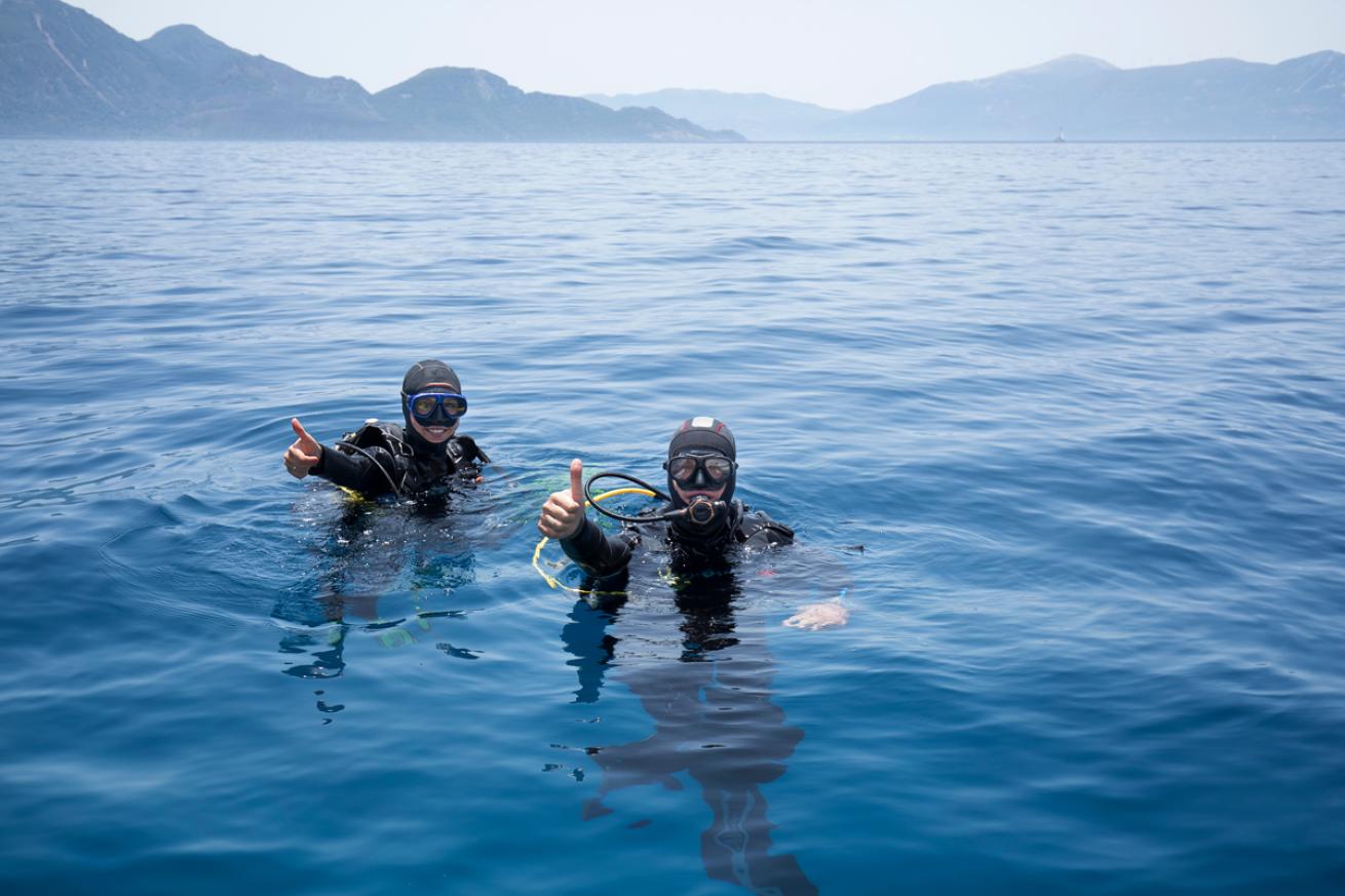 Two Scuba Divers Thumbs Up