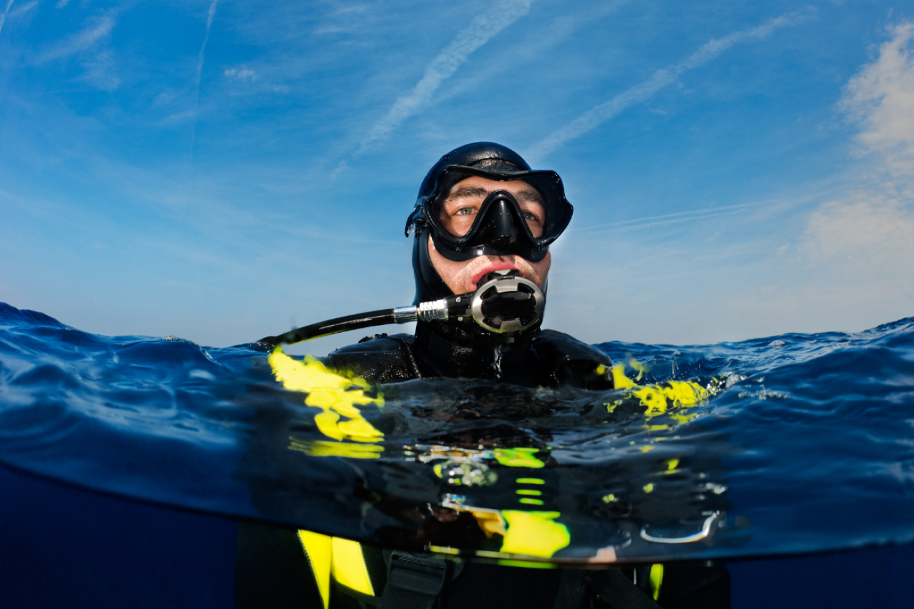 A male in scuba gear in the water