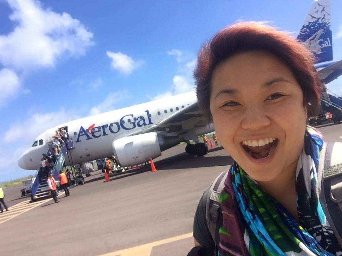 Smiling traveler with plane