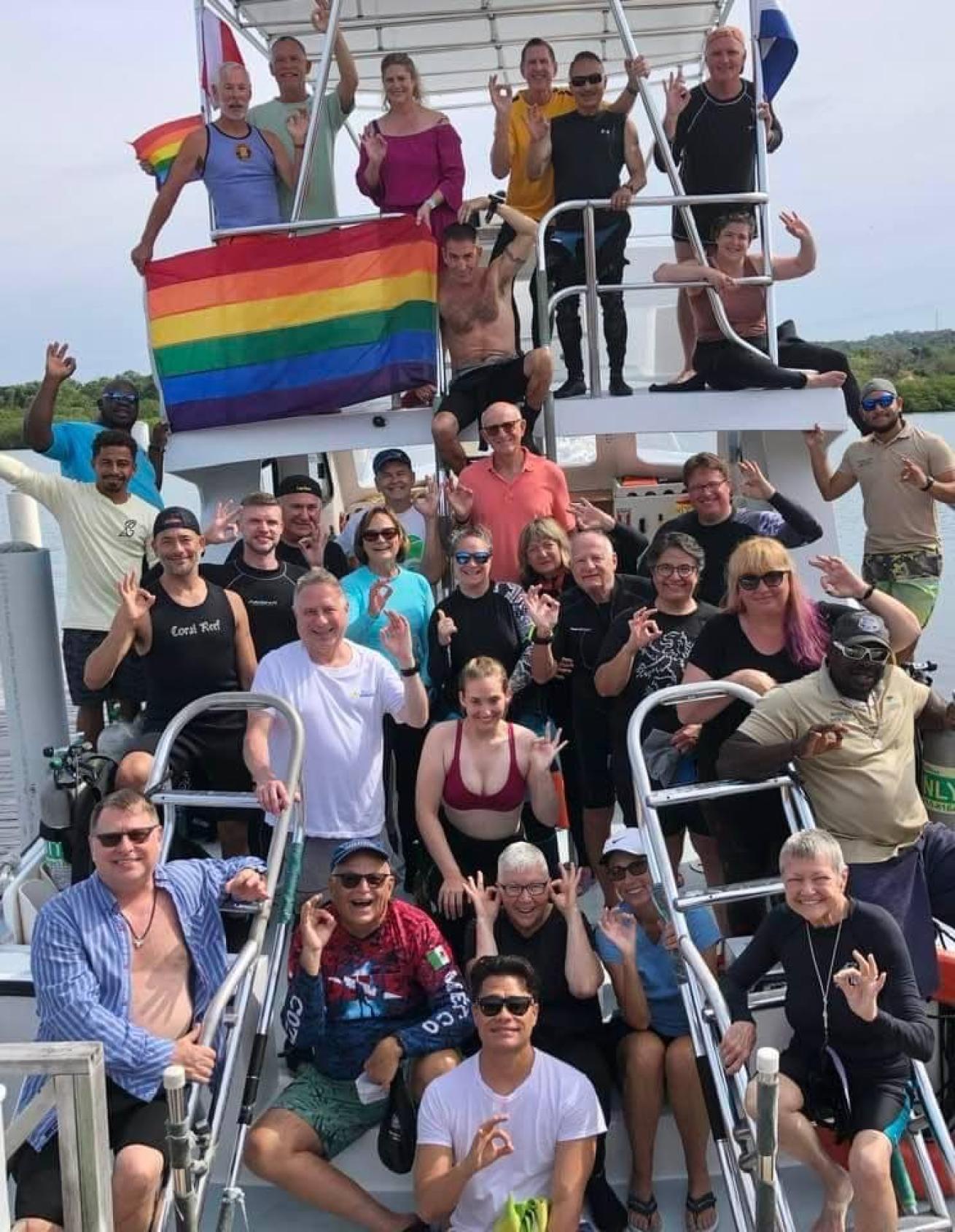 Divers on boat with pride flag