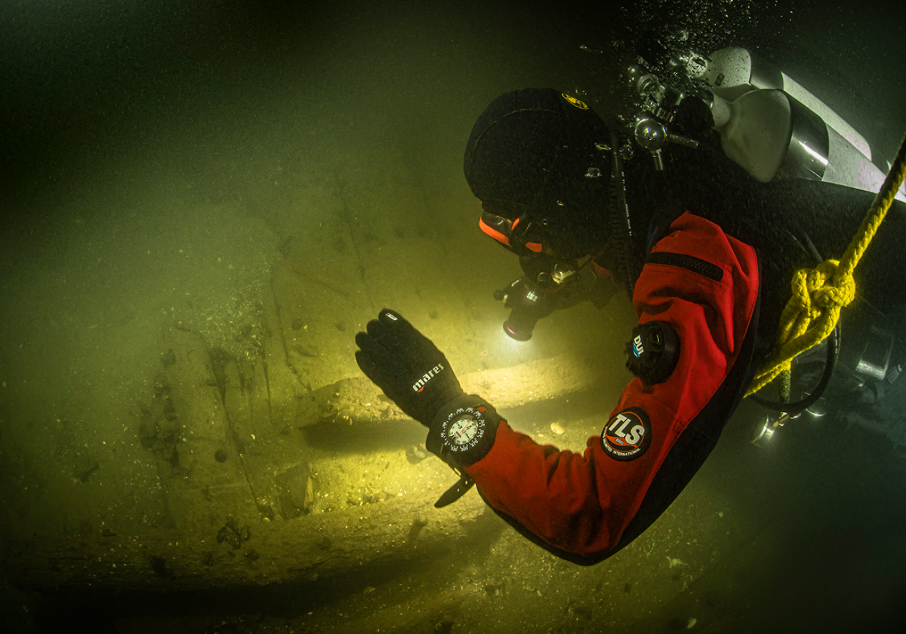 Research diver using flashlight