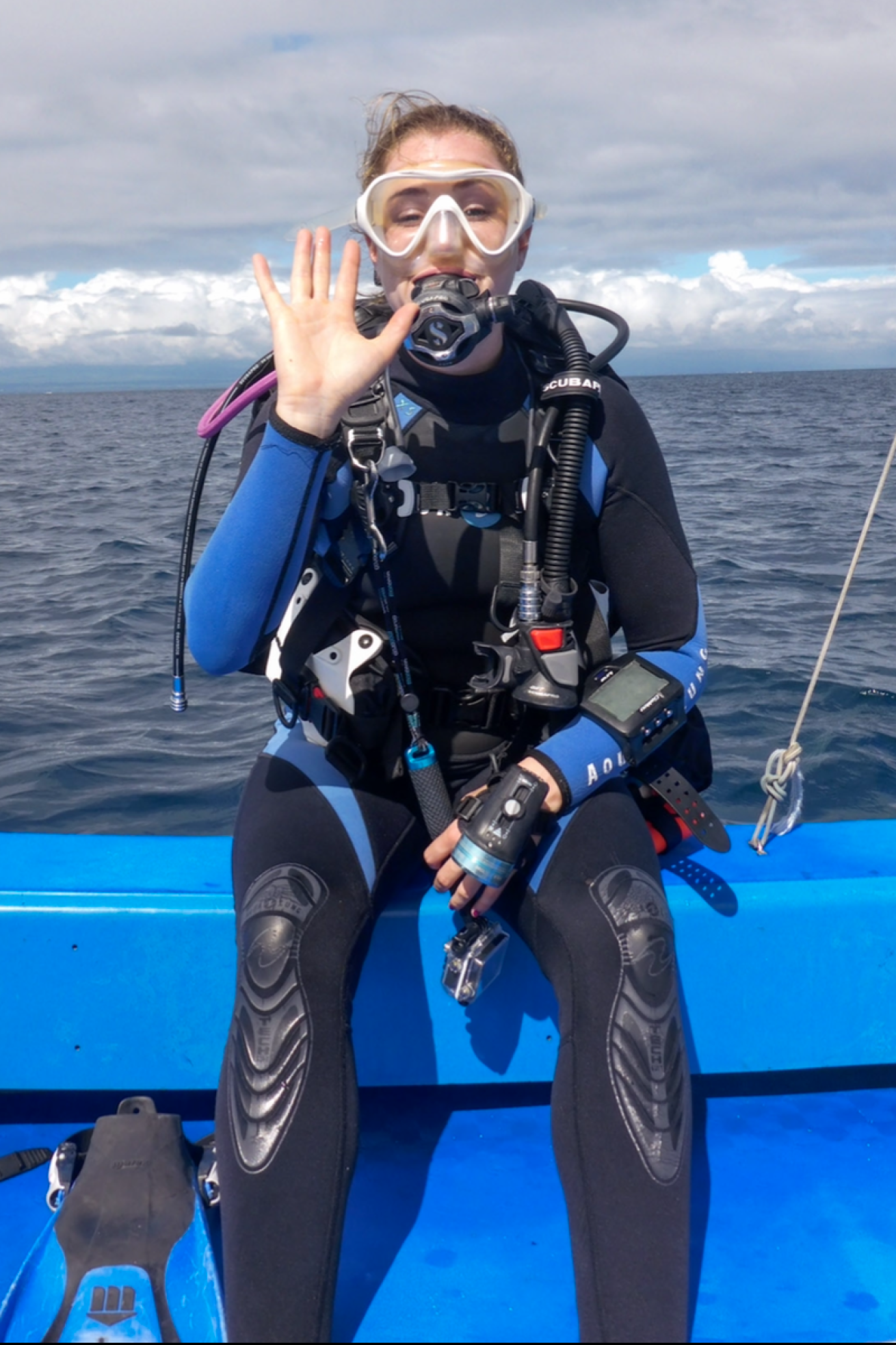 Diver is set for her dive from a boat.