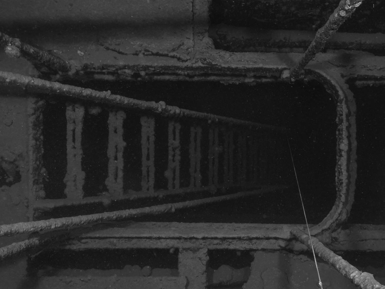 Stairs in the sunken ship Tokai Maru leading into darkness.