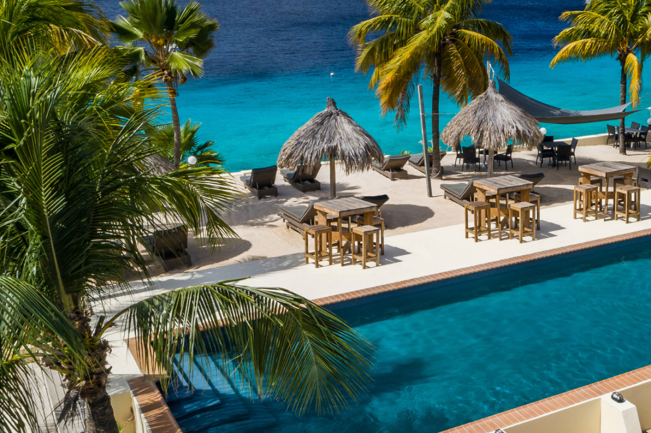 A pool with chairs and umbrellas