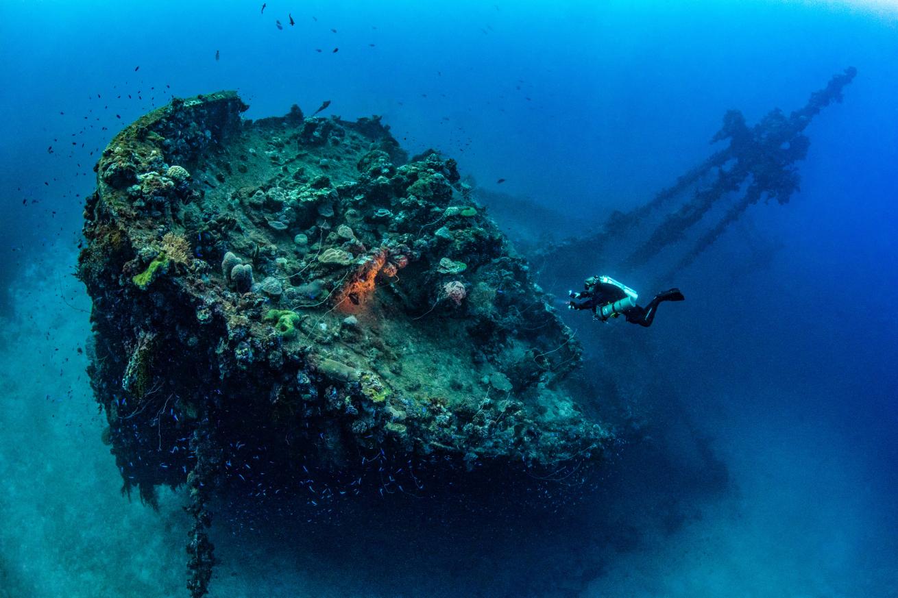 A tech diver explores a shipwreck.