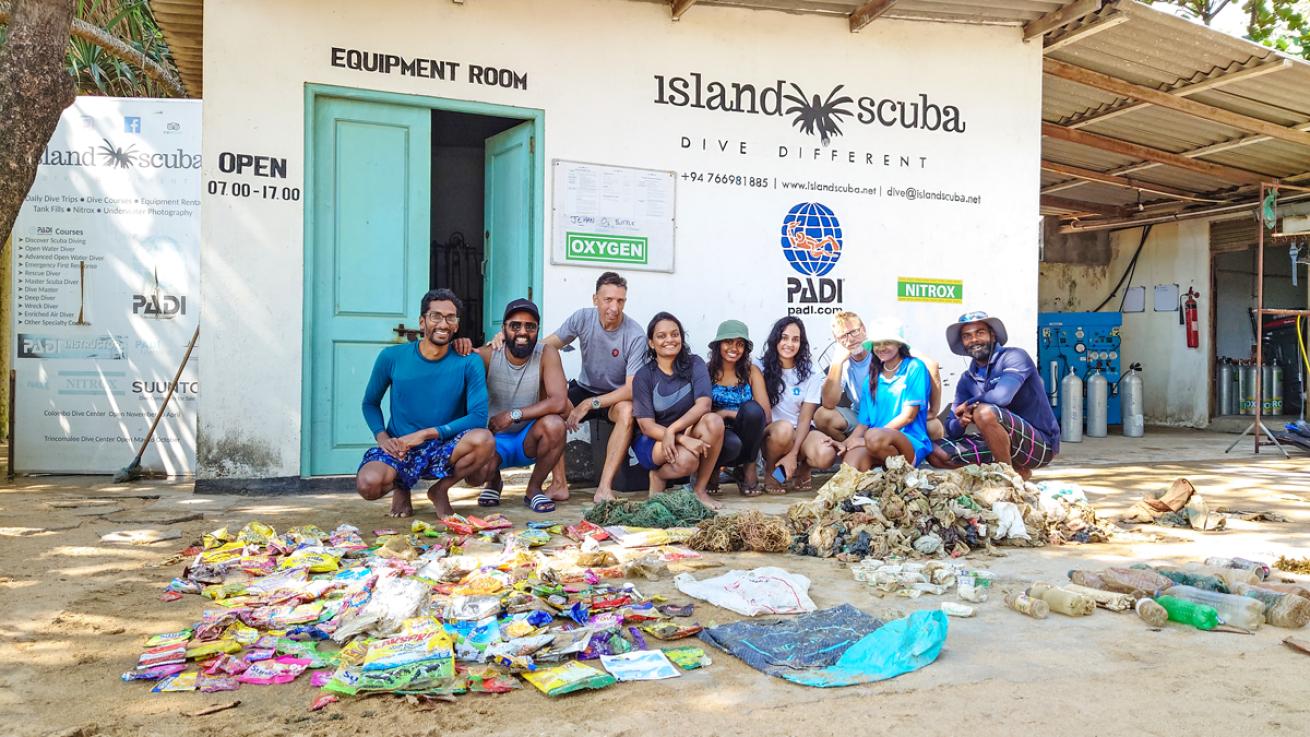 Katuwawala and volunteers display the waste collected at Palagala Reef after an underwater cleanup in Colombo, Sri Lanka.
