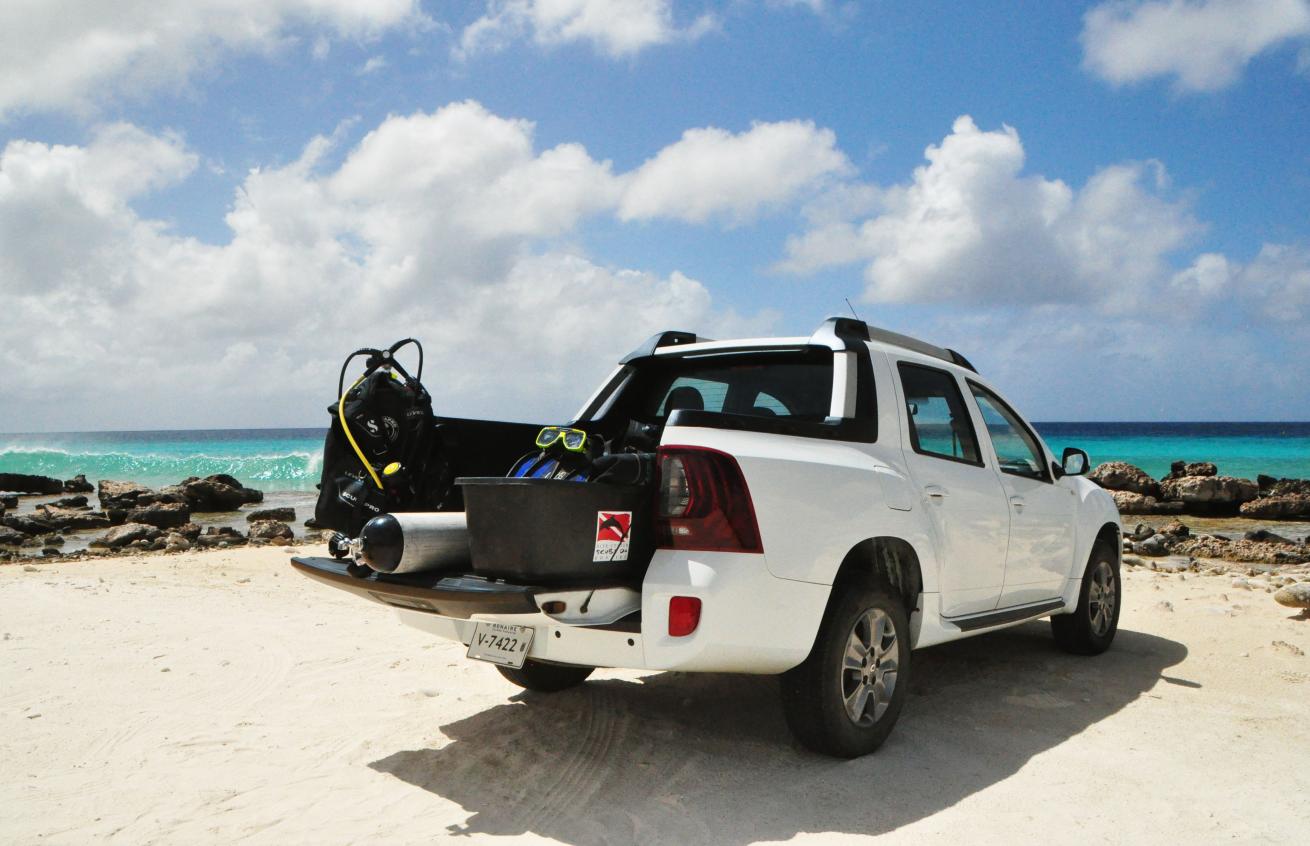 Truck with scuba gear parked at beach