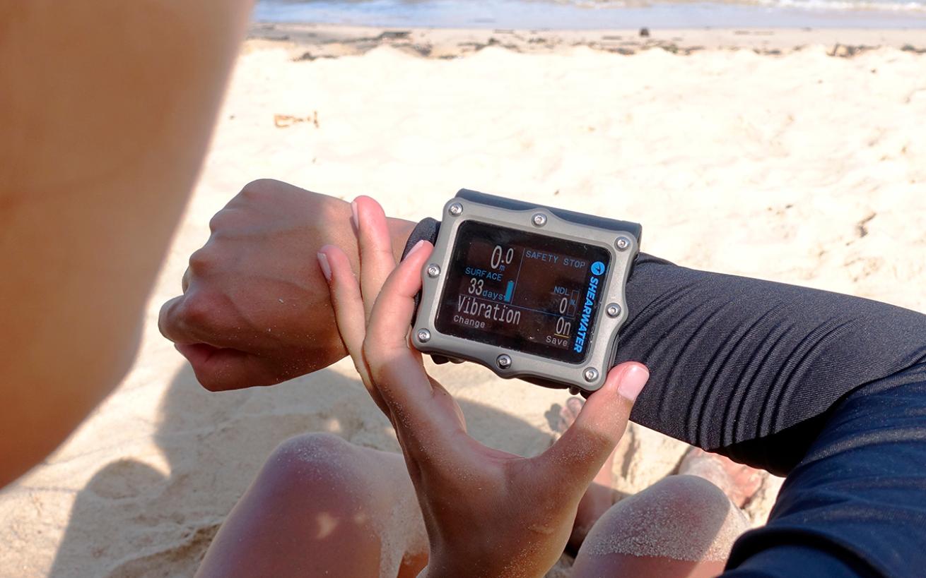 Person looking at dive computer on their wrist