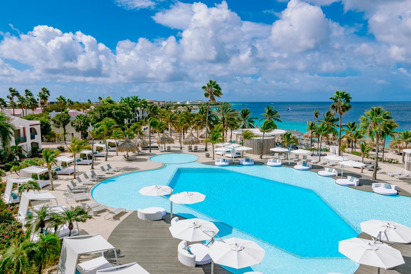 Resort pool with beach view.