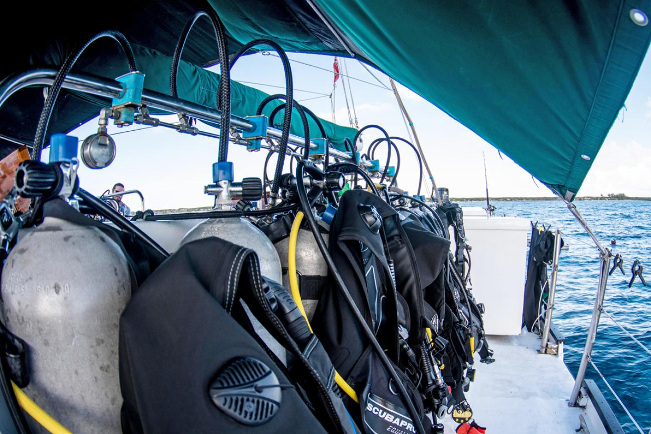 Rental Scubapro regs and BCs are staged on the deck of a Blackbeard’s Cruises liveaboard vessel.