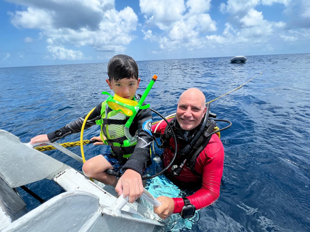An instructor teaches a young diver aboard Belize Aggressor III.