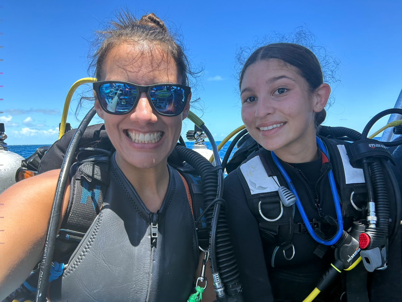 Two women in scuba gear smiling on a boat in Key West, Florida