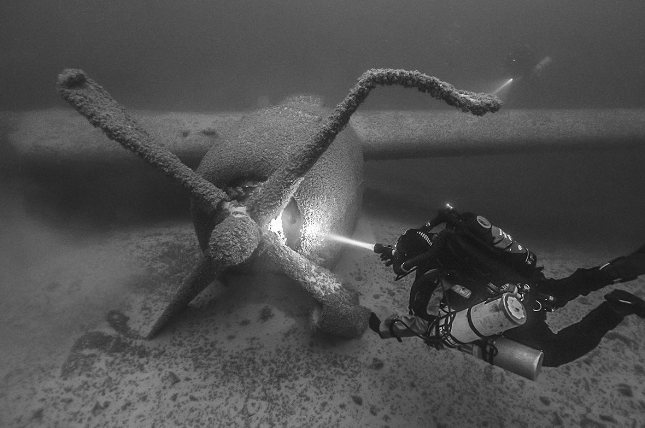 scuba diver engine wreck black and white