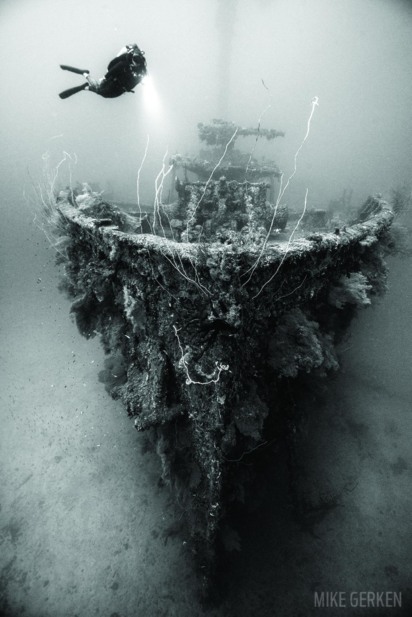 Scuba diver underwater diving in Truk Lagoon Shipwreck
